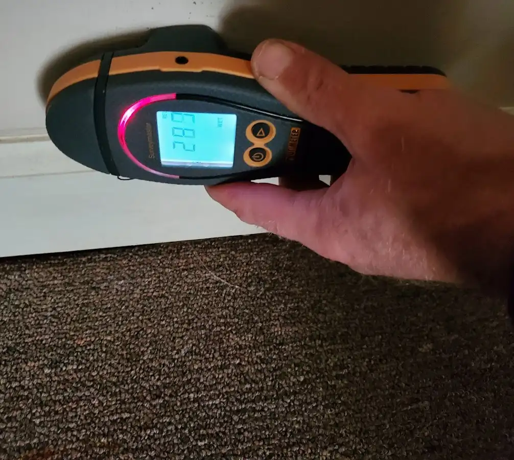 Moisture detection at baseboard during Storm Damage Restoration in Walton